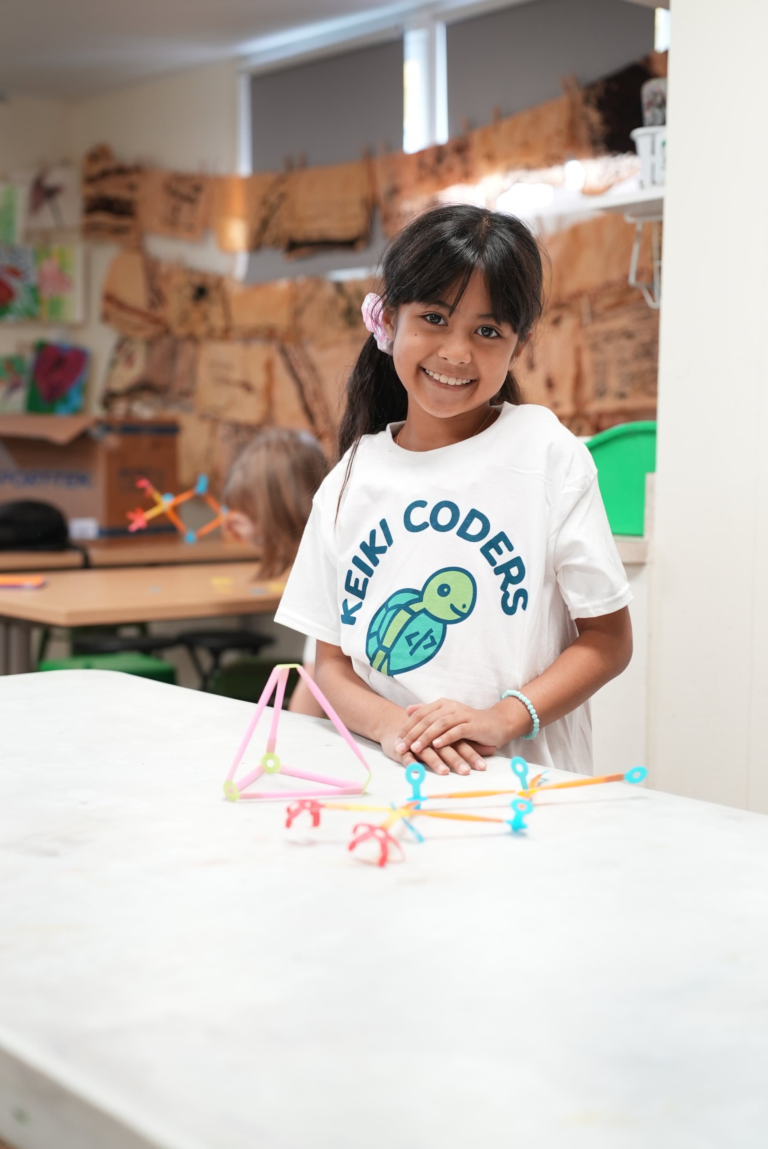 Keiki Coders students working together on a project at their school.