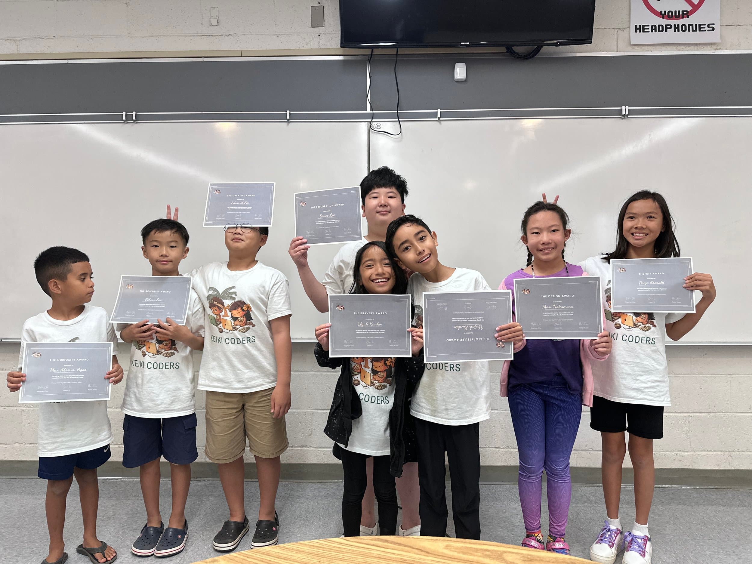 Kids holding coding awards in classroom in Honolulu.